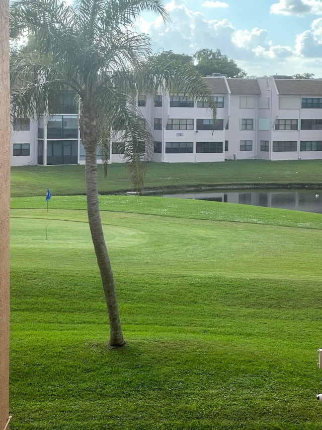 view of property's community featuring a water view and a yard