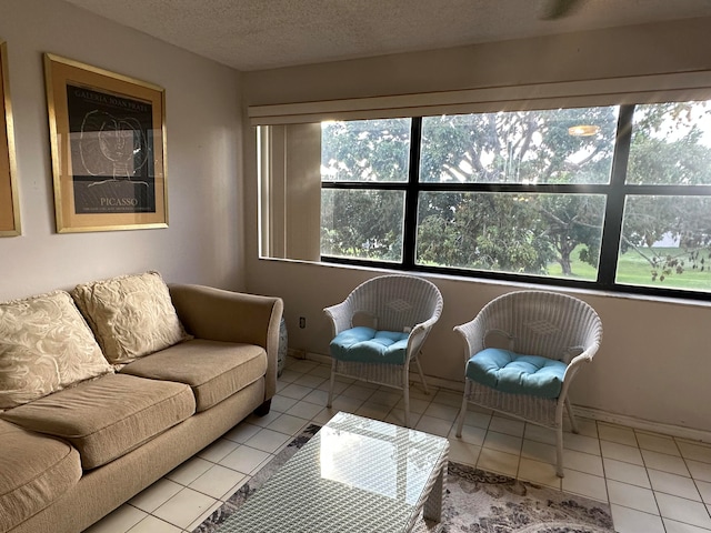 tiled living room featuring a textured ceiling