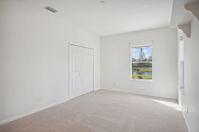 empty room with light colored carpet