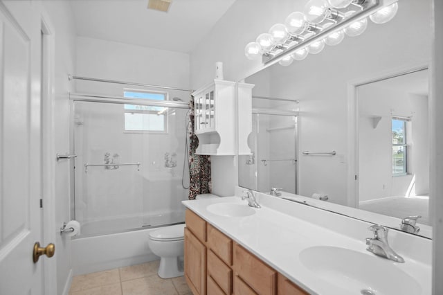 full bathroom with combined bath / shower with glass door, toilet, a wealth of natural light, and tile flooring