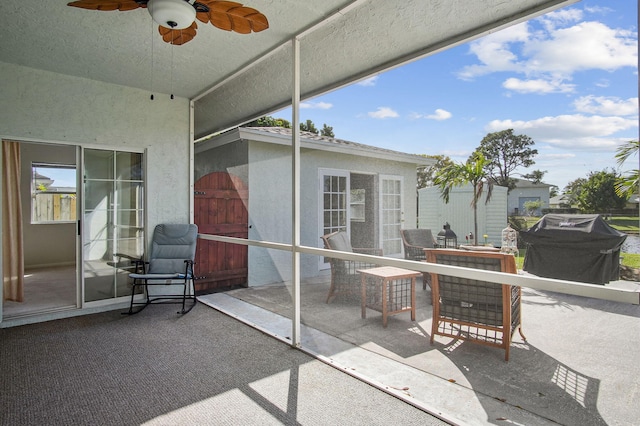 sunroom / solarium featuring ceiling fan