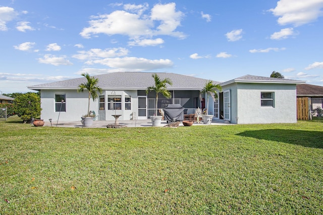 rear view of house with a patio area and a yard