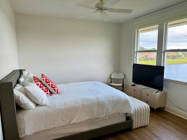 bedroom with ceiling fan and dark wood-type flooring