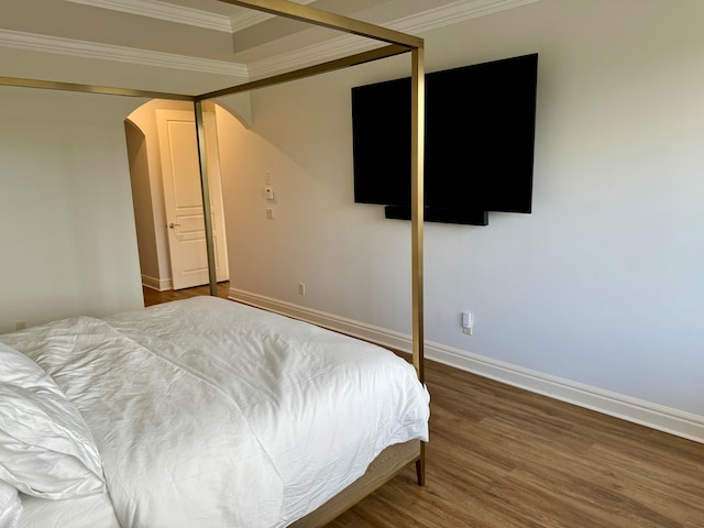 bedroom featuring ornamental molding and dark hardwood / wood-style floors