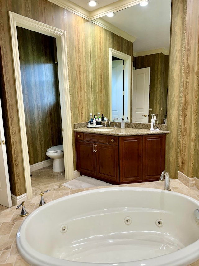 bathroom featuring wooden walls, toilet, ornamental molding, vanity, and a bathing tub