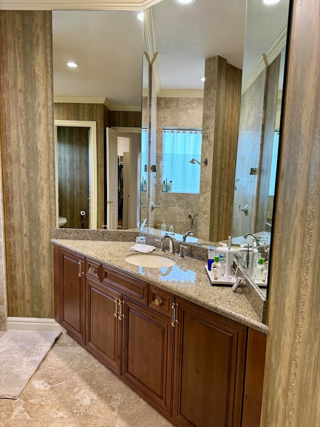 bathroom featuring tile floors, ornamental molding, and vanity