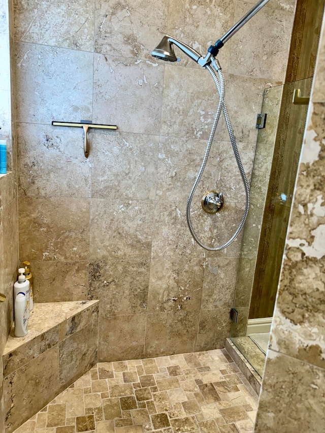 bathroom with tiled shower