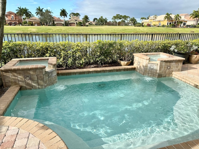 view of pool featuring pool water feature and an in ground hot tub