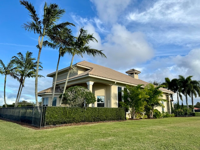 view of side of property featuring a yard