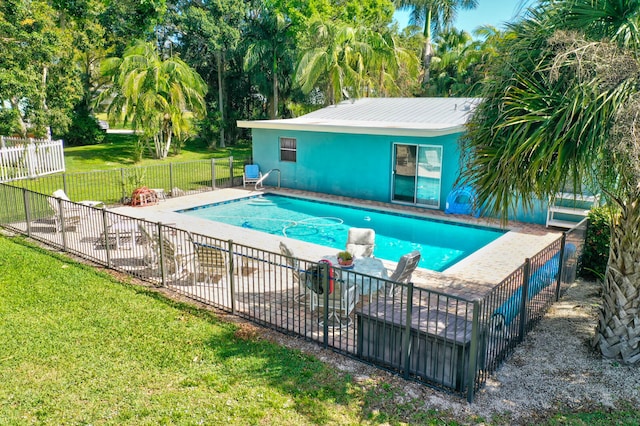 view of swimming pool with a yard and a patio area