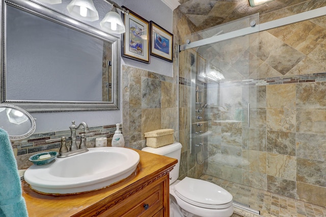 bathroom featuring a shower with shower door, vanity, tile walls, and tasteful backsplash