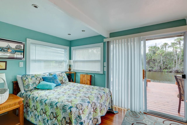 bedroom featuring beam ceiling and hardwood / wood-style floors