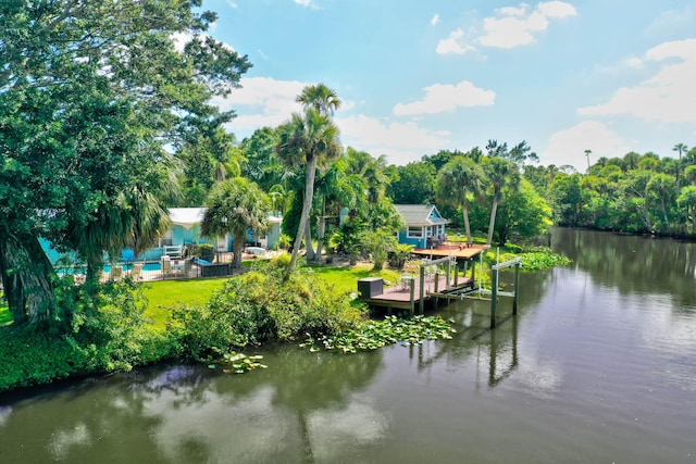 dock area with a yard and a water view