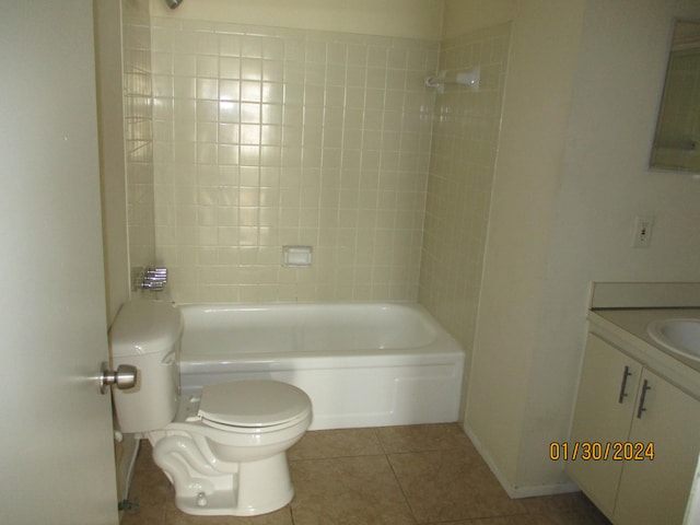 full bathroom featuring tiled shower / bath combo, vanity, tile floors, and toilet