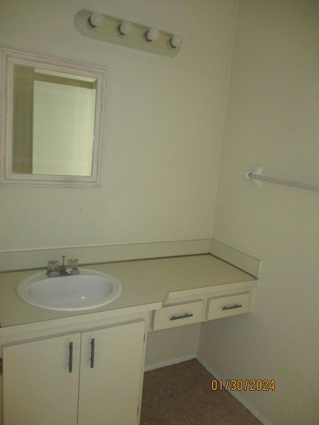 bathroom with vanity with extensive cabinet space and tile flooring