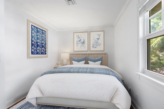 bedroom featuring ornamental molding and hardwood / wood-style floors