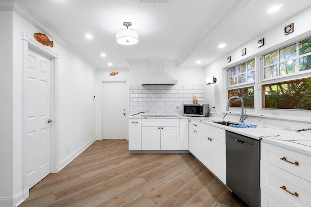 kitchen with sink, white cabinetry, backsplash, premium range hood, and black appliances