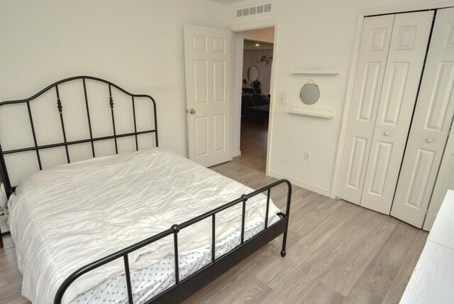 bedroom with a closet and light wood-type flooring