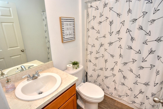 bathroom featuring vanity, toilet, and hardwood / wood-style flooring