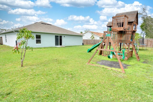 view of jungle gym featuring a trampoline and a lawn