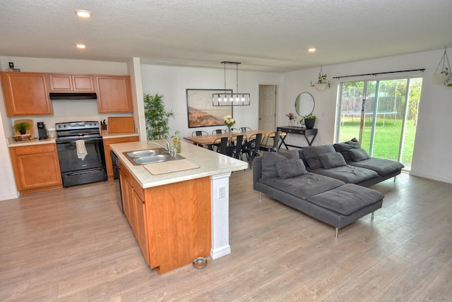 kitchen featuring electric range, a notable chandelier, sink, light hardwood / wood-style flooring, and pendant lighting