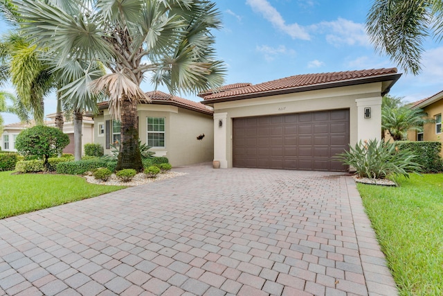 mediterranean / spanish home featuring a garage and a front yard