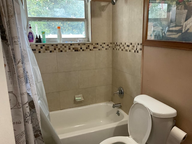 bathroom featuring shower / tub combo and toilet