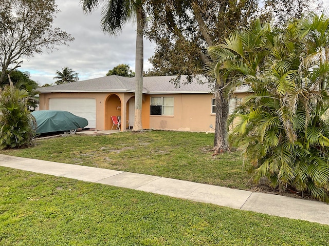 view of front facade with a front yard and a garage