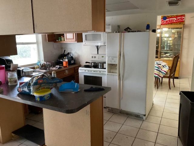 kitchen with white appliances, sink, and light tile floors