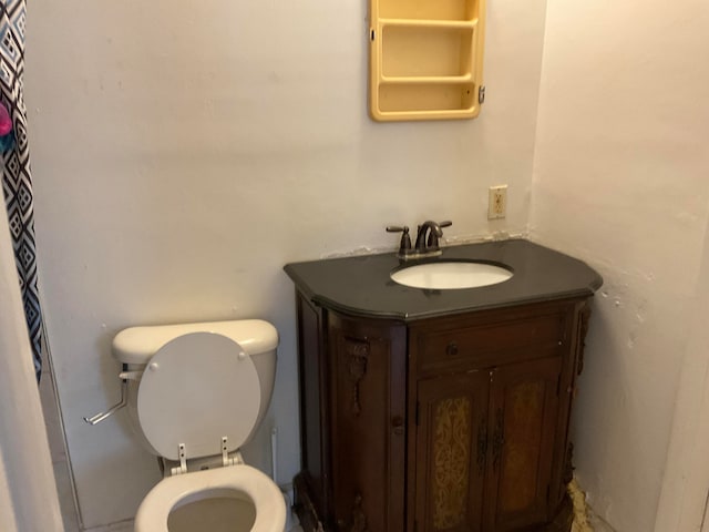 bathroom with large vanity and toilet