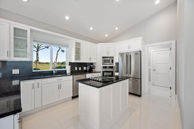 kitchen with sink, appliances with stainless steel finishes, light tile flooring, white cabinetry, and a center island