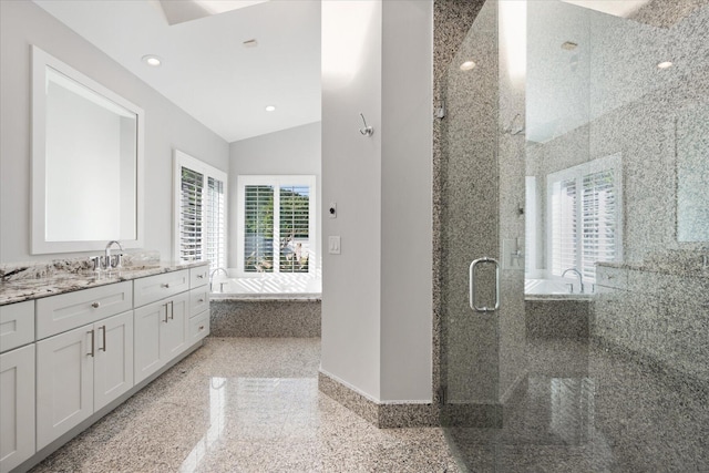 bathroom with separate shower and tub, vanity, and vaulted ceiling