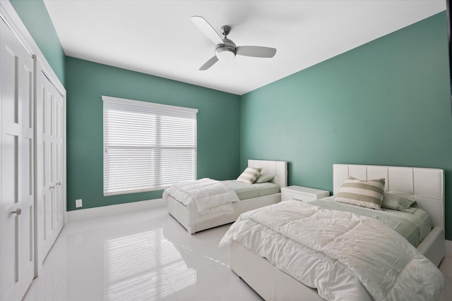 tiled bedroom featuring ceiling fan