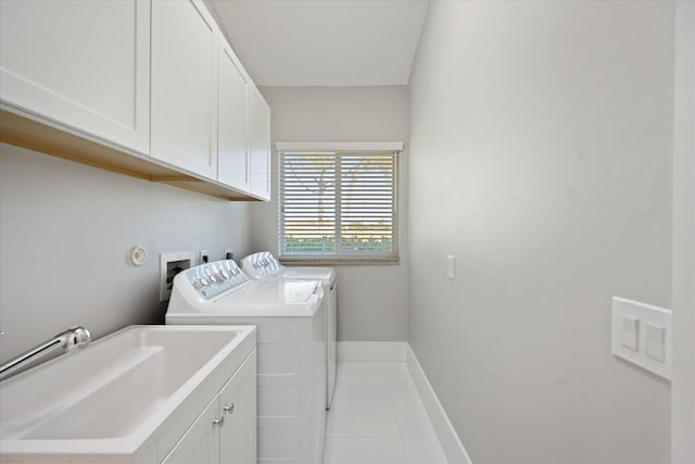 clothes washing area featuring sink, light tile floors, hookup for a washing machine, cabinets, and separate washer and dryer