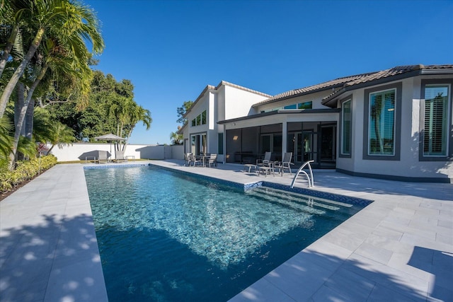 view of swimming pool with a patio area