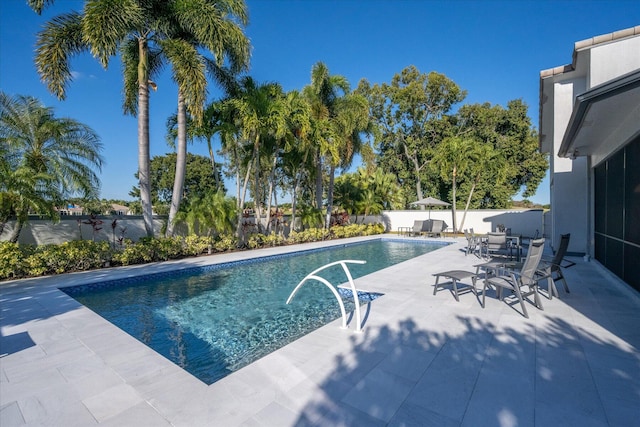 view of swimming pool featuring a patio area