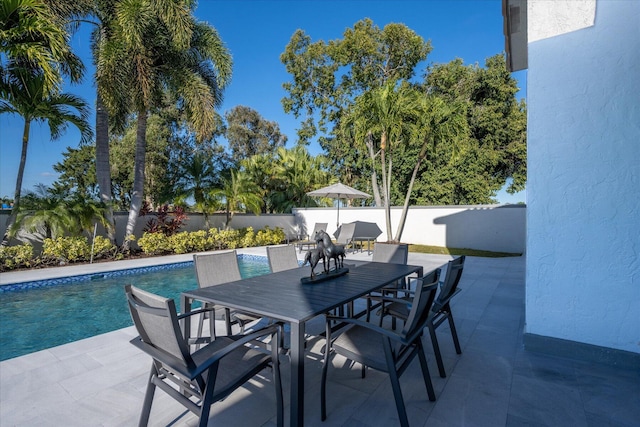 view of terrace with a fenced in pool