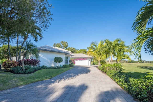 view of front of property with a front lawn and a garage