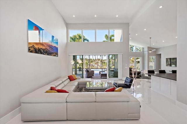 living room featuring light tile flooring and a high ceiling