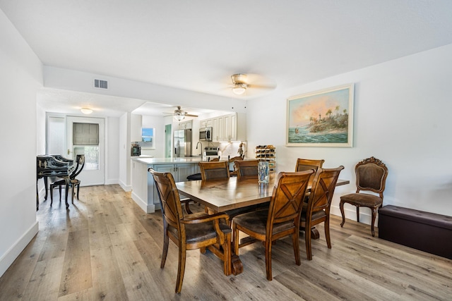 dining space featuring ceiling fan and light hardwood / wood-style flooring