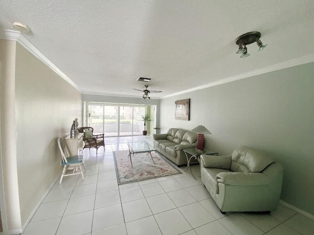 tiled living room featuring a textured ceiling, ceiling fan, and crown molding