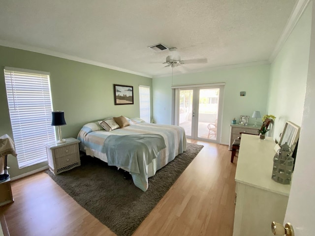 bedroom with ceiling fan, access to exterior, wood-type flooring, and crown molding