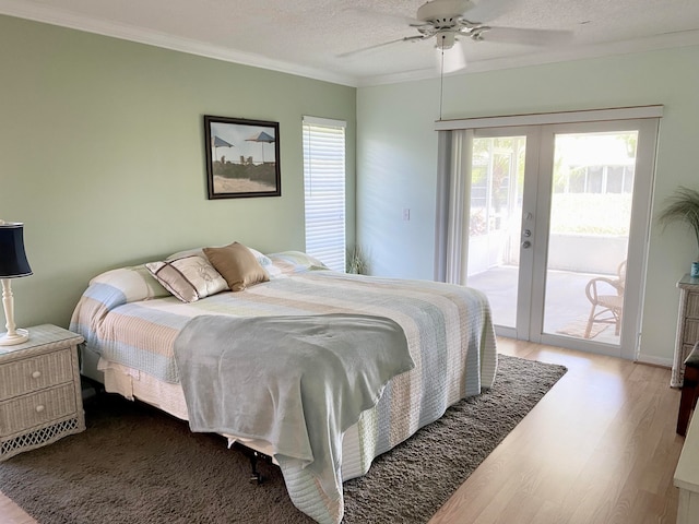 bedroom featuring access to outside, multiple windows, french doors, and wood-type flooring