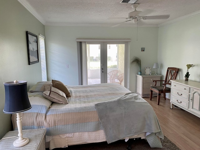 bedroom with access to exterior, french doors, ceiling fan, crown molding, and wood-type flooring