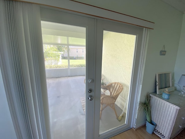 entryway with light hardwood / wood-style flooring and french doors