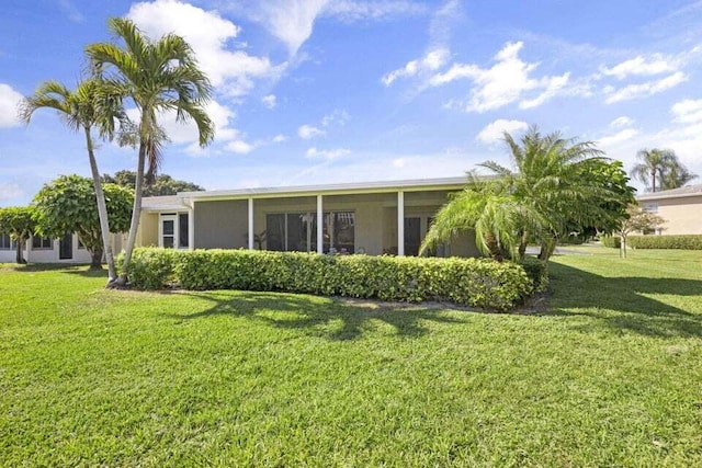 back of house featuring a lawn