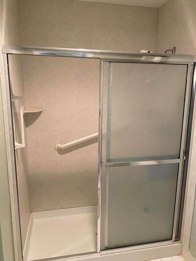 bathroom with a shower with shower door