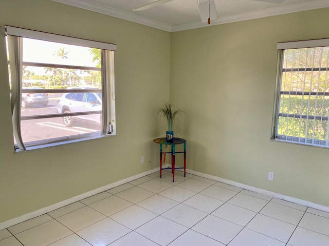 spare room with light tile patterned floors, ceiling fan, and crown molding