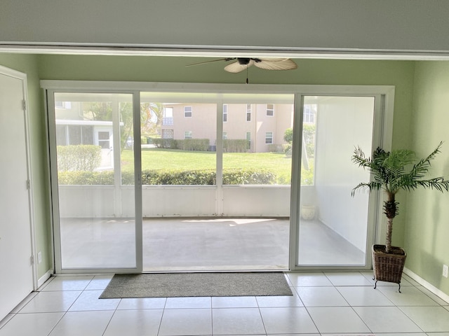 entryway featuring ceiling fan, light tile patterned floors, and a wealth of natural light