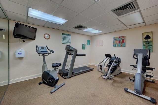 gym with a drop ceiling and carpet